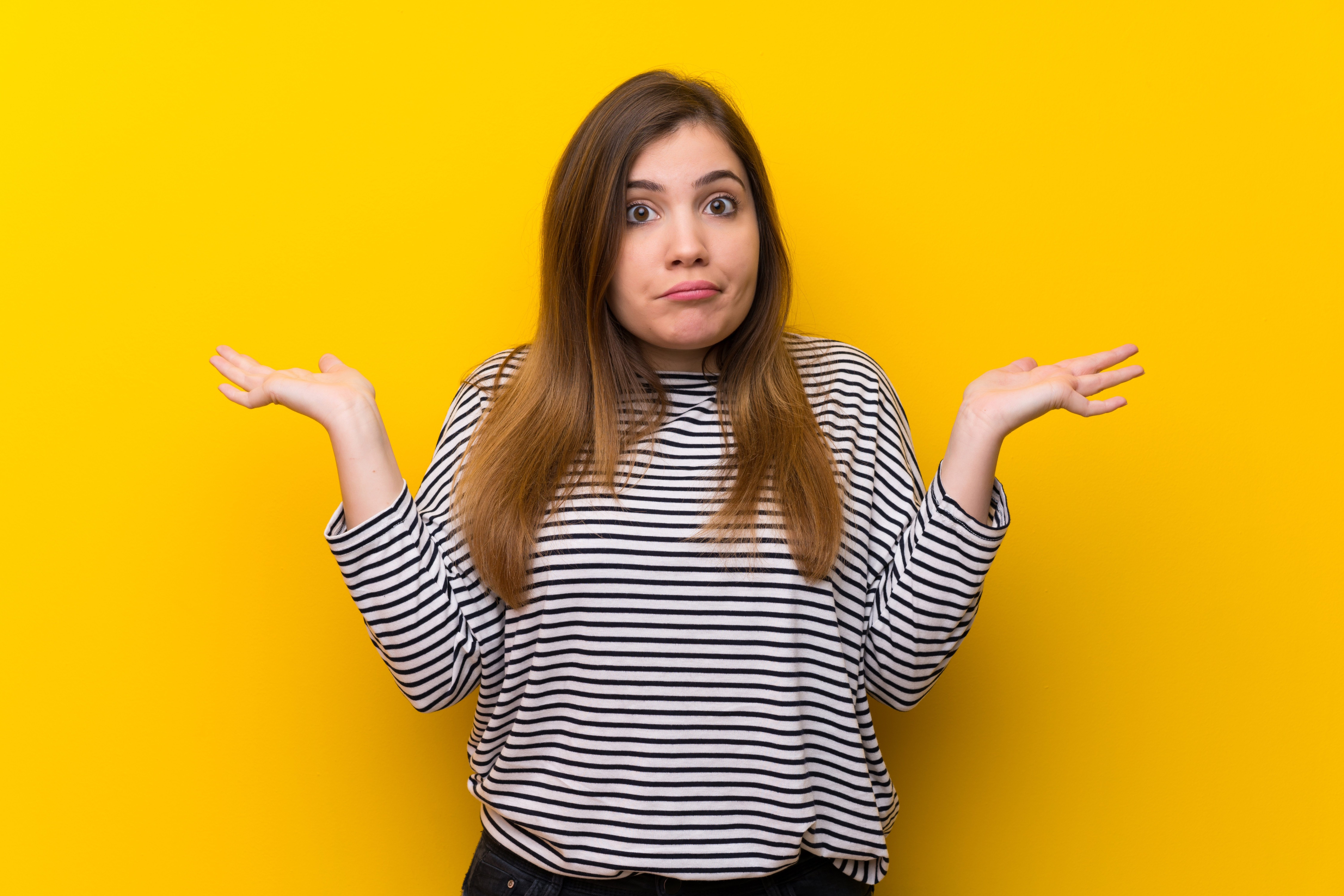 young girl over yellow wall